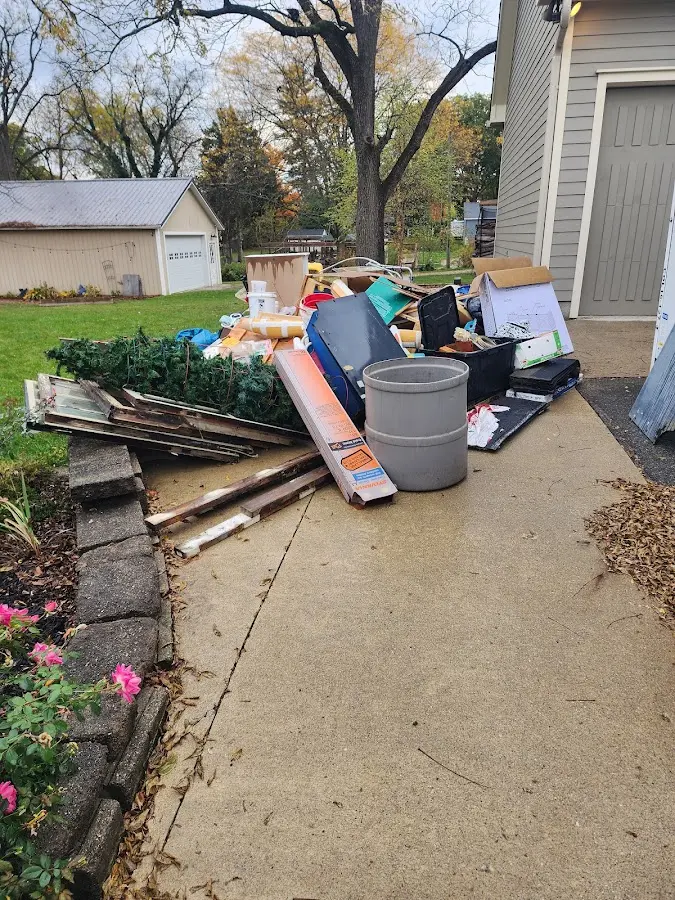 Dumpster being loaded with debris for Estate Cleanout Dumpster Rental in Independence